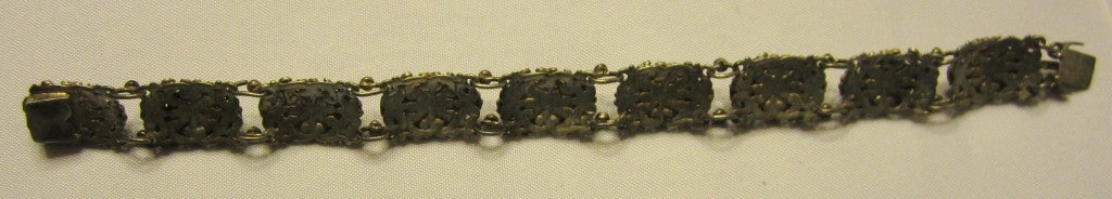 Offered for sale in this intricate and highly ornate and decorative Austro-Hungarian filigree bracelet with turquoise-colored cabochon stones.  The metal seems to be gold and silver washed and the tongue of the bracelet is marked Hungary with two