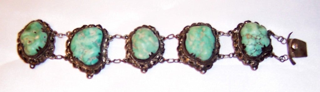 Offered for sale is this stunning Chinese turquoise bracelet comprised of five large and roughly cut turquoise stones framed onto silver-toned filigree bezels.  The bracelet is marked China on its clasp, measures approximately 7 1/2