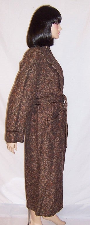 This is a luxurious and opulent, women's winter robe, made of a fine jacquard woven brocaded fabric of brunt umber, yellow ochre, and burnt sienna and designed by Kathie Keller of New York.  The robe is fully lined, beautifully constructed, with all