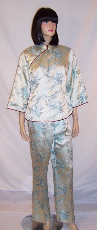 This is a lovely and luxurious, 1960's vintage, custom made, pale blue Chinese silk brocade lounging ensemble.  The jacket has 3/4 length sleeves, a side zipper on the right for closure, and a series of snaps that go from the right side to the