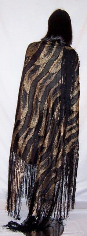 Offered for sale is this stunningly dramatic, 1920's French black and gold lame shawl in a stylized Art Deco leaf or feather design.  The shawl itself measures 44