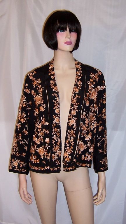 This is a strikingly beautiful, 1920's vintage, apricot and black silk Chinese hand-embroidered jacket. The jacket has no buttons and its interior is lined with pale apricot silk, which is in very good condition. The jacket would be equivalent to a