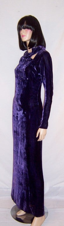 This is a stunning, 1930's vintage, violet silk velvet gown with a modified halter neckline and triangular cut-outs in both the front and the back of the bodice.  The bodice is fitted and adorned with clear rhinestones.  The gown is cut on the bias