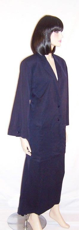 This is a fabulous and early Claude Montana midnight navy, Size 8, two piece suit with a modified train, made in Italy.  The outfit is masterfully constructed and very detailed with snap closures for the skirt as well as the jacket. It is made of