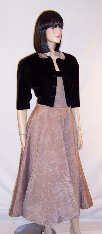 This is simple and elegant, 1950's vintage, muted pink strapless gown with a matching black velvet bolero jacket.  The fabric is quite wonderful and resembles a raw textured silk with light ribbing, a faille, combined with a moire type of treatment