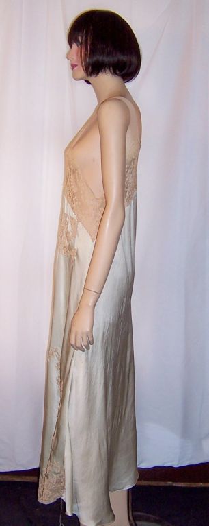 This is a lovely 1920's, palest of turquoise, silk negligee accentuated with intricate ecru lace appliques. It measures 32