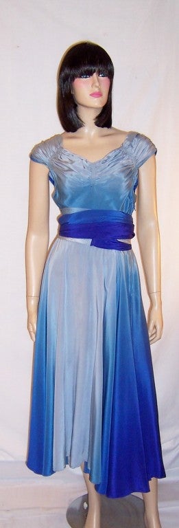 This is a stunningly beautiful, early 1940's, hand-dyed silk gown in a ombre treatment, in all of the gradations of the color blue from a deep Prussian blue, to cobalt blue, to cerulean blue, to a powder blue. The gown has a side zipper for closure,