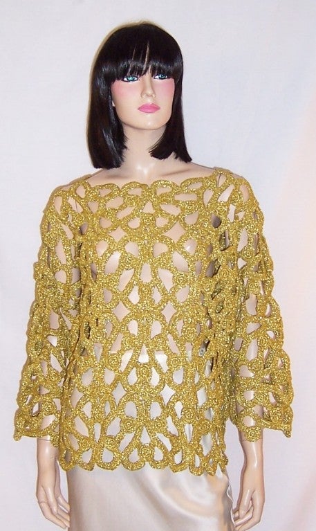 This is a fabulous metallic gold, open-crocheted sweater designed by Michael Simon of New York for Henri Bendel.  The sweater is made of linen, nylon, and polyester and is marked One Size Fits All. It measures 21
