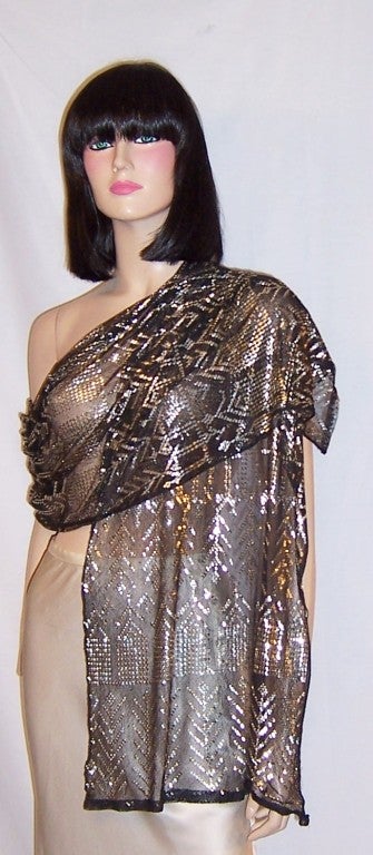 This is a stunning, 1920's vintage, Assuit Egyptian shawl of hammerd silver on black tulle.  The shawl measures 17