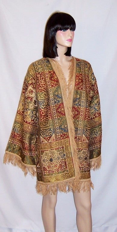 This is an handsome, 1920's vintage, silk brocaded Bohemian jacket in hues of yellow ochre, rust, cream, and teal green.  The jacket had been designed to be worn open and has no fasteners for closure. The entire jacket, including its wide cuffs have