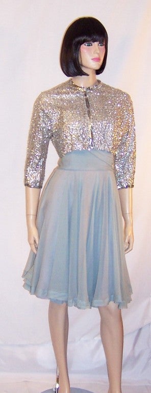 This a gorgeous Ceil Chapman, strapless, pale blue silk chiffon cocktail dress with matching silver sequined bolero jacket, probably dating to the 1950's vintage.  The dress has a fitted bodice which has been embellished with silver sequins. It has