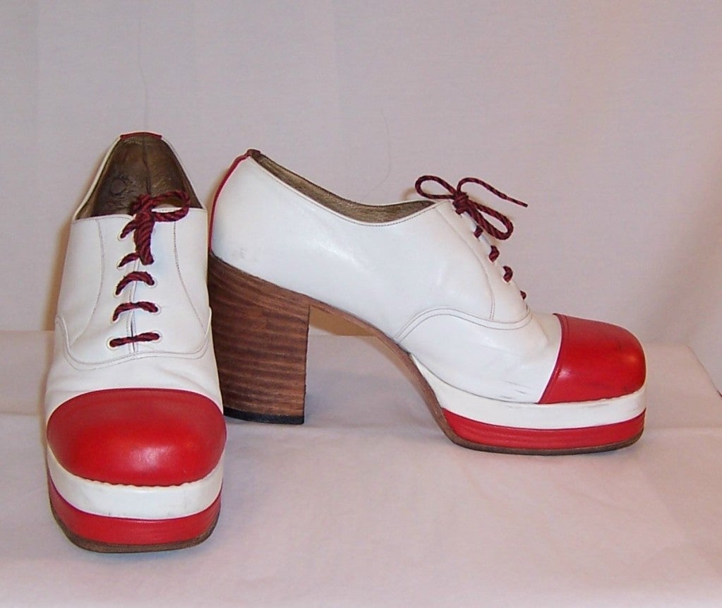 This is an unusual pair of men's original 1970's red and white leather, rock band/disco platform shoes.  The pair is in very good vintage condition with some minor scuff marks on the side and right front area of the left shoe, as shown in the