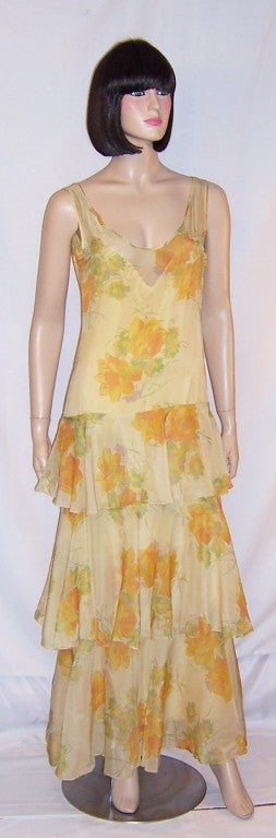 Offered for sale is this delightful Art Deco/Gatsby silk, yellow floral printed gown with a scooped-out neckline in the front and a lower scooped-out neckline in the back.  The gown comes with its own attached rayon slip with a side zipper for