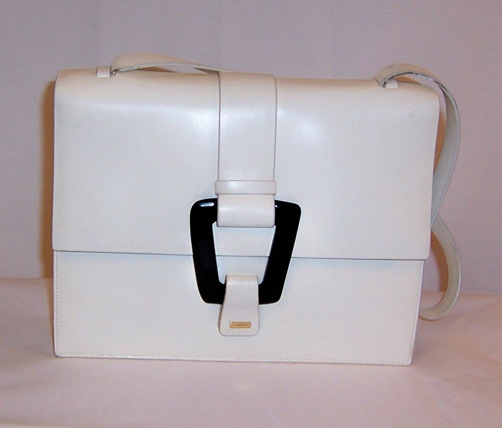 This is a fine white leather summertime handbag designed by Gucci. It measures 10 1/2