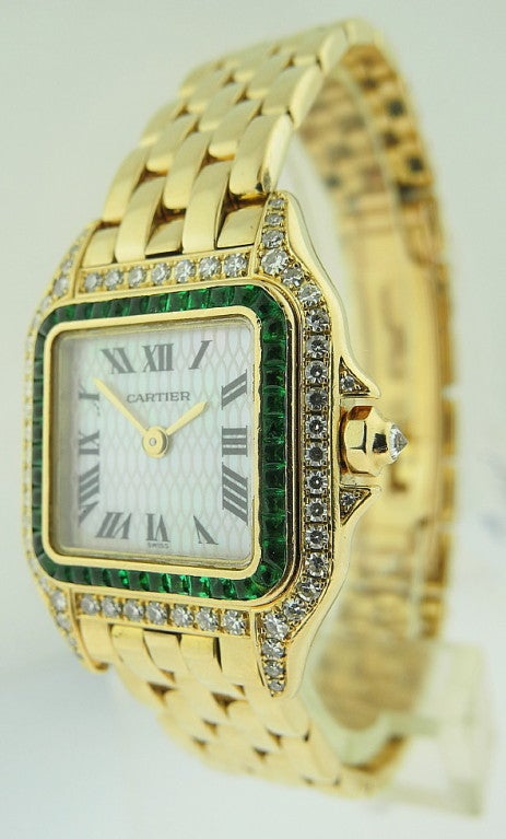 This is a Cartier lady's bracelet quartz wristwatch 18k yellow gold 'Panthere' with mother of pearls structured dial. Emeralds and diamond case& crown, comes with 18k yellow gold link bracelet. Manufactured in 1997. Accompanied by the original