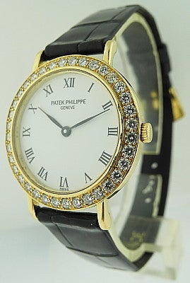 This is a Patek Philippe, 18k yellow gold Calatrava with diamond bezel Ref 4820. Quartz ladies wristwatch with white enamel dial, comes with PP black leather strap and PP 18k yellow gold buckle. Last known retail price $21.000. Manufactured in circa