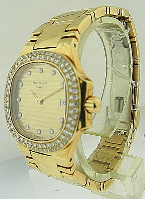 This is a Patek Philippe ladies 18k yellow gold 'Nautilus' with full diamond bezel, Ref. 4700/054. Manufactured in circa 2000'. Comes with 18k yellow gold link bracelet and 18k white gold deployant clasp. Accompanied by the certificate of origin. 44