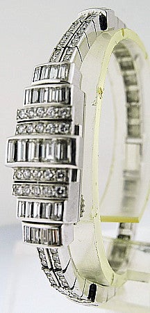 This is a Audemars Piguet, Ladies Art Deco Platinum and Diamond Backwind Bracelet-Watch. Geometric design, the cover set with alternating rows of baguette and round diamonds, completed by a slender two row bracelet continuously set with single-cut