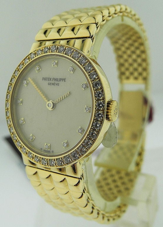 Up for sale is a Patek Philippe. An 18K yellow gold and diamond-set wristwatch with bracelet.Signed Patek Philippe, Genève, No. 1607465, recent with quartz movement, the cream dial with diamond-set dot numerals, the circular case with diamond-set