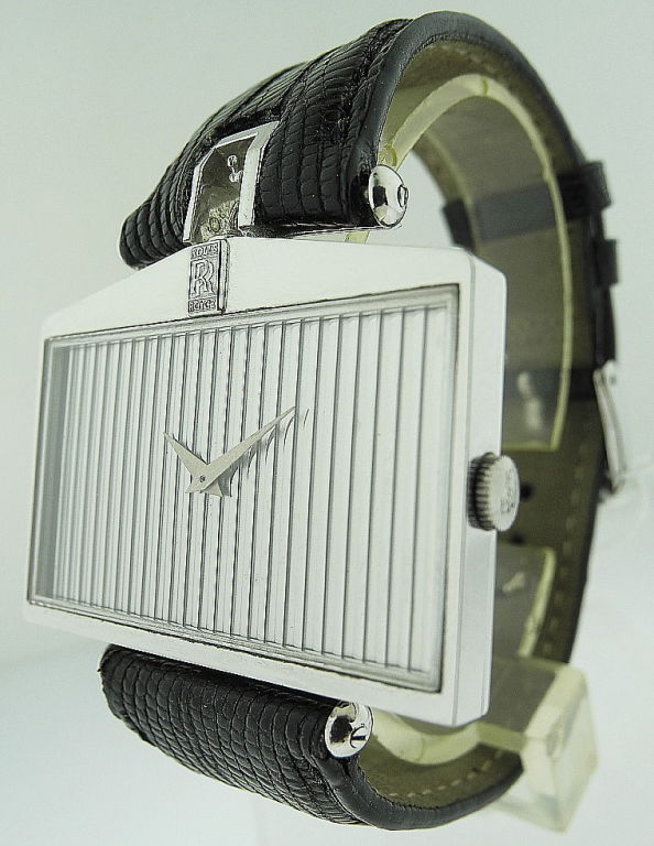 This is a Corum 18k White Gold, 'Rolls Royce' Spirit of Ecstasy. Made circa 1980’s. Fine and unusual, large size pentagonal 18K white gold with grille dial men's wristwatch with black leather strap.