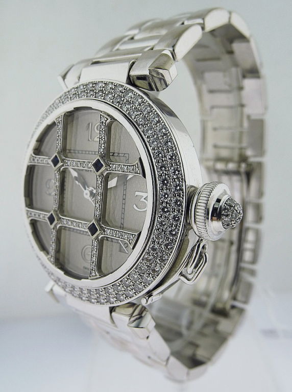 This is a Cartier 18k white gold, 'Pasha Grille' with diamond grill bezel wristwatch, Ref. 2373. Made circa 2000. Fine, center-seconds, self-winding 18k white gold wristwatch with date and a Cartier 18k white gold bracelet and Cartier deployant
