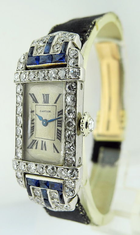 This is a Cartier fine and rare ladies' platinum rectangle diamond & sapphire Art Deco wristwatch, No.7724. <br />
<br />
Manufactured circa 1925. Comes with black fabric strap and 18k pink gold deployant buckle.