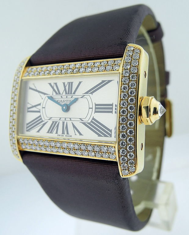 This is a Cartier, fine 18K gold lady's wristwatch set with diamonds Divan, Ref:2601, No. 267489CE. Manufactured in circa 2003. Quartz movement, rectangular brushed silvered dial with elongated roman chapters, blued hands, the bezels of the