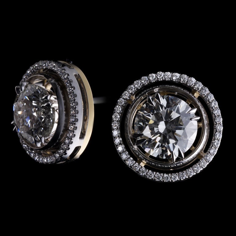 A pair of diamond stud earrings with Alexandra Mor Diamond knife edged signature Jackets.  Center diamonds weigh a total of 4.06 Cts. Diamonds are Ideal cut and extremely bright. (Color I-J  Clarity: SI1/SI2) Earring jackets contain Alexandra Mor