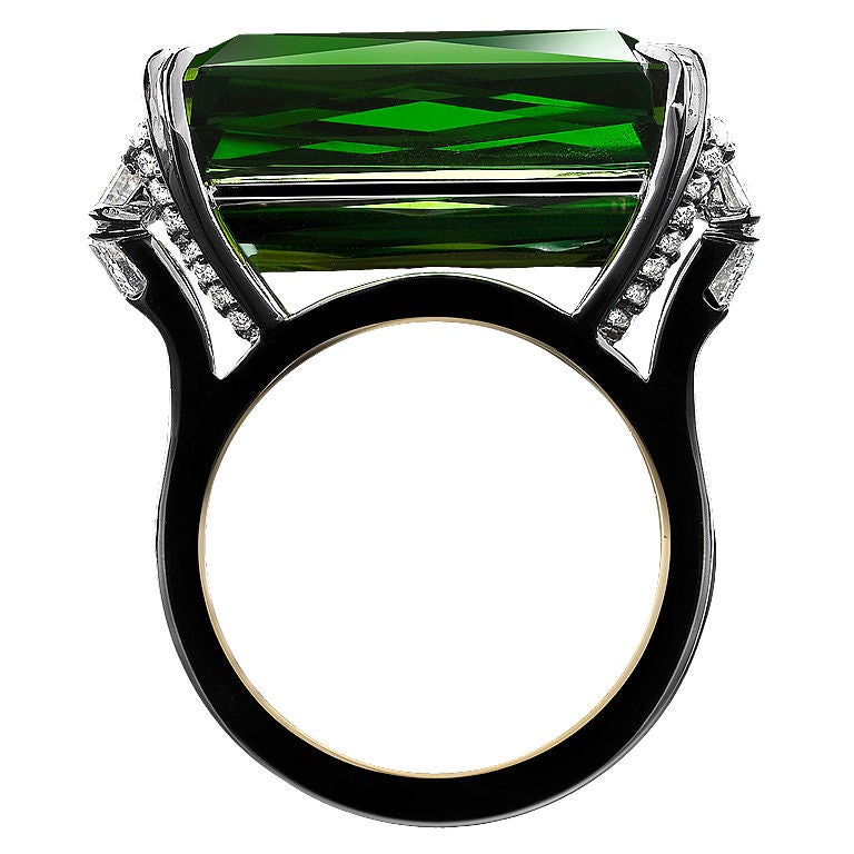 An Alexandra Mor signature Ring containing a 18.23 carat scissor- cut rectangular green- Tourmaline ring flanked by diamond baguettes diamond  trapezoids weighing a total of 1.44 carats.   Signed by artist. Limited Edition  1/5