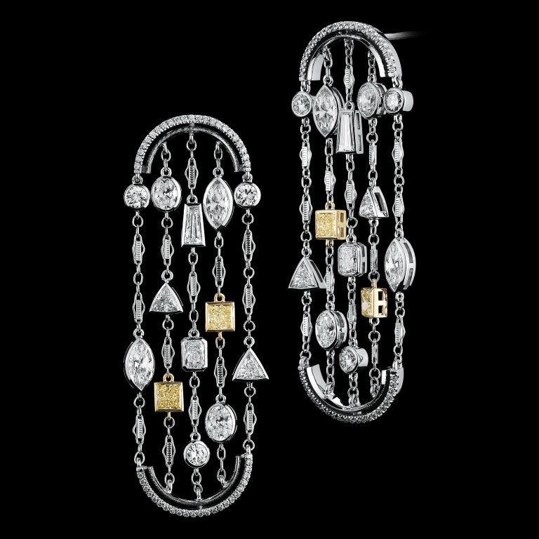 These arched earrings feature a mixture of Brilliant, Radiant, Oval, Marquise, Trillion, Baguettes and Princess Cuts Diamonds. Earrings are set in 18 karat white gold and suspended by arches detailed with Alexandra Mor's signature floating Diamond