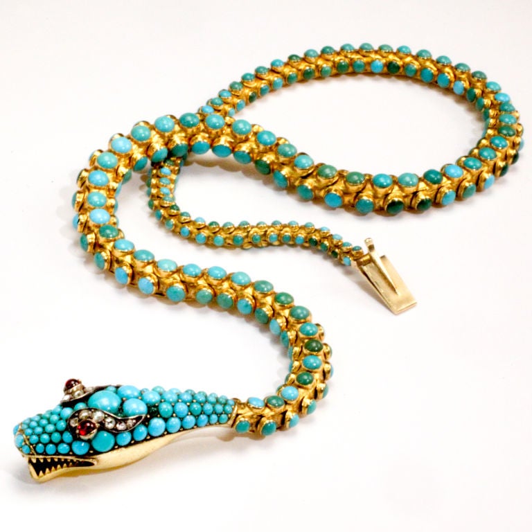 Victorian 19th century turquoise and gold snake necklace.  Fully articulated snake with hundreds of bezel set cabochon turquoise beads mounted in 18 karat gold.  Finely detailed snake head completely encrusted with turquoise beads.  Cabochon ruby