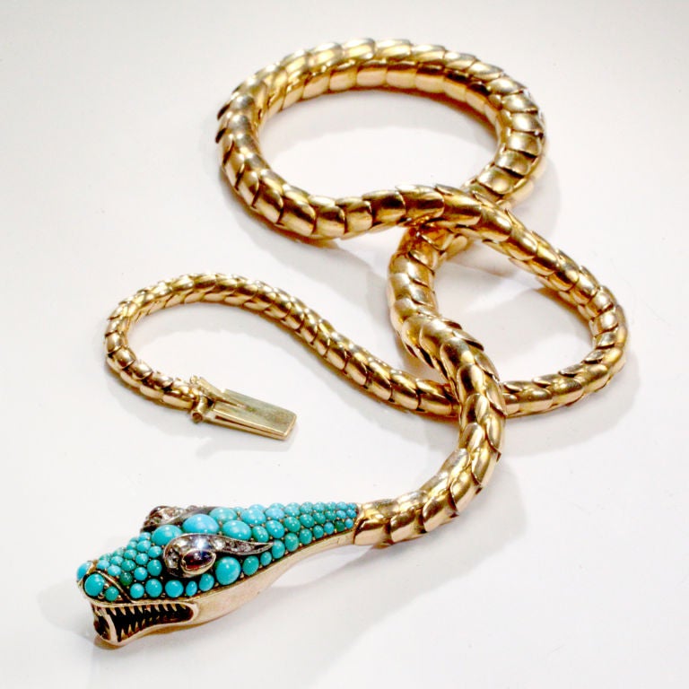 19th century 18 karat gold snake necklace with head completely encrusted with cabochon turquoise beads.  Cabochon ruby eyes and diamond accents.  Tails clasps into head for closure.  Victorian serpent jewelry was a symbol of eternal love!