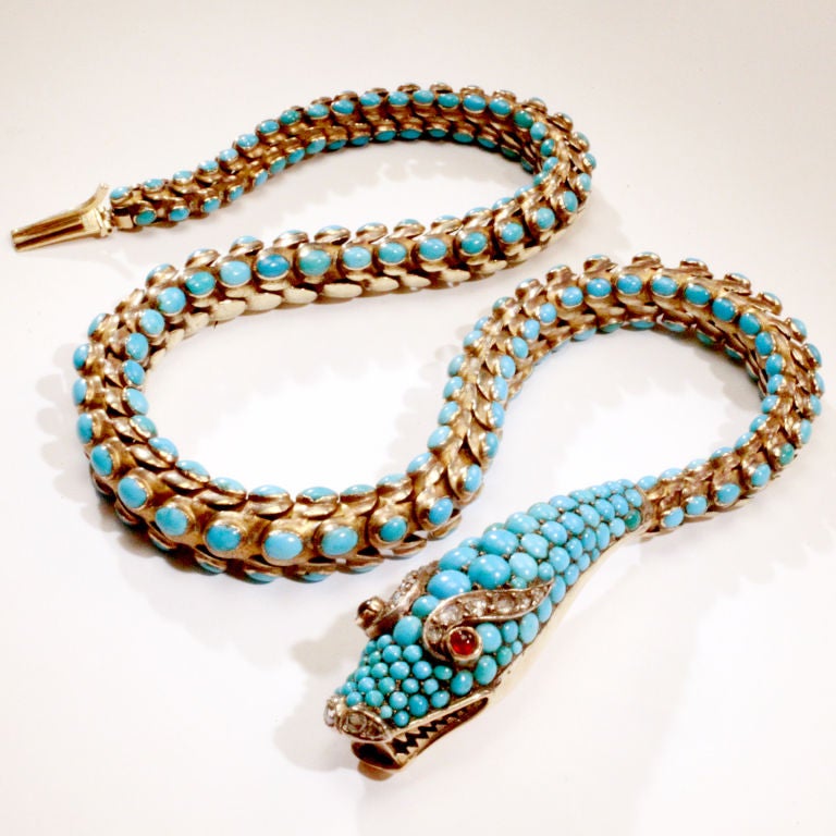 Victorian 19th century turquoise and 14 kt. gold snake necklace.  Fully articulated snake with hundreds of bezel set cabochon turquoise beads mounted in gold.  Finely detailed snake head completely encrusted with turquoise beads.  Cabochon ruby eyes