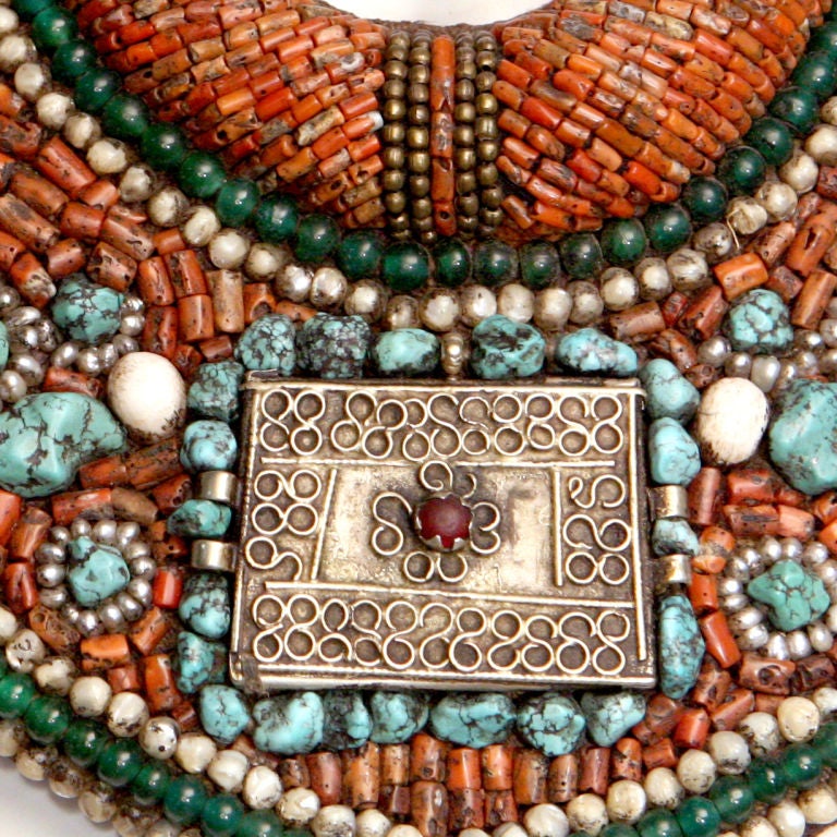 Incredible rare vintage ethnic collar necklace.  Large bib style which ties with braided roping.  Overall pattern set with hundreds of stones including amber, turquoise and malachite. Distinctively outlined in jasper and pearlized gray beads. 