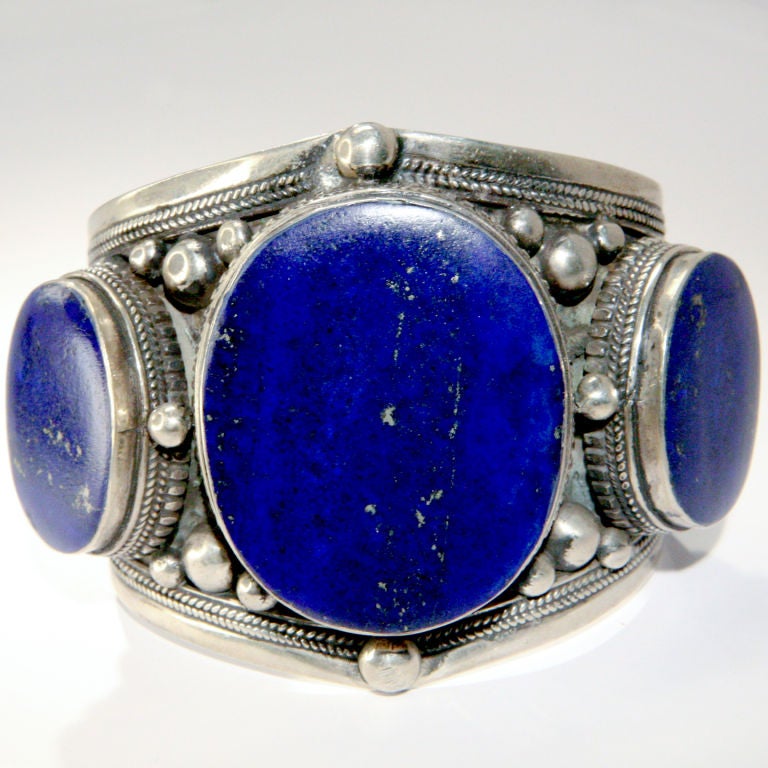 Extra-large engraved silver cuff with hand wrought silver ball detail and three large bezel set deep blue lapis stones.  The over-sized center stone 1.75
