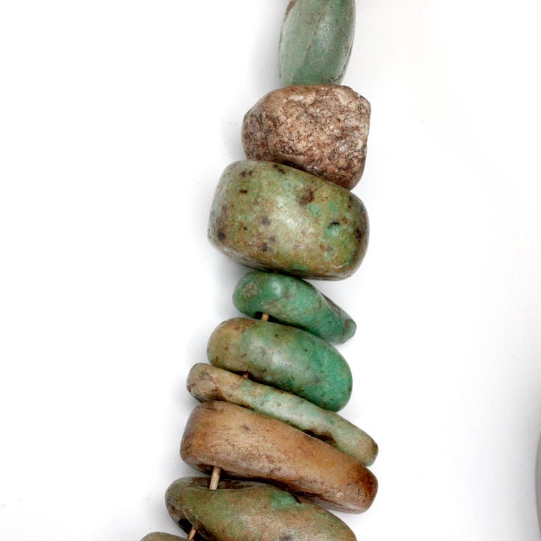 Unique polished stone necklace with natural turquoise colored stones strung on hemp cording.  Can be worn or displayed as an art object.