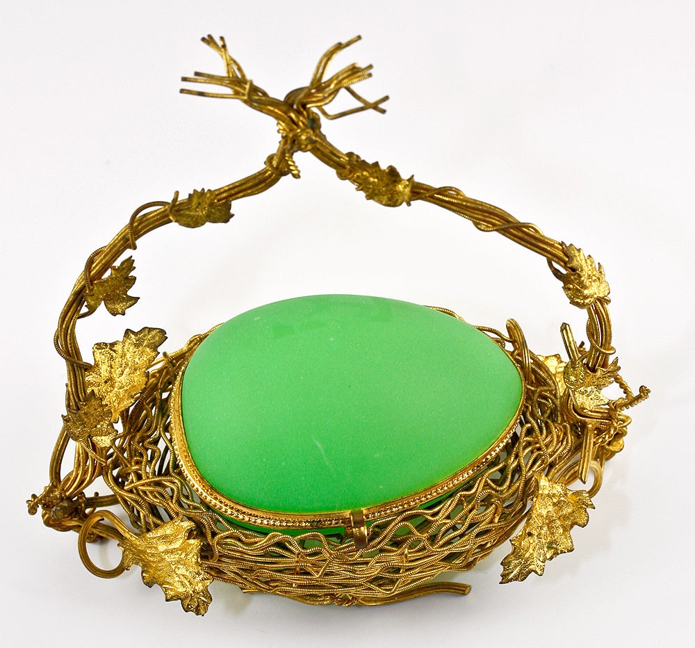 Nested and with braided raised branches that form an arch over the beautiful old opaline 'egg', this one is a much sought after form and color, green being one of the most rare of all opalines. We've been selling our opalines back to France and to