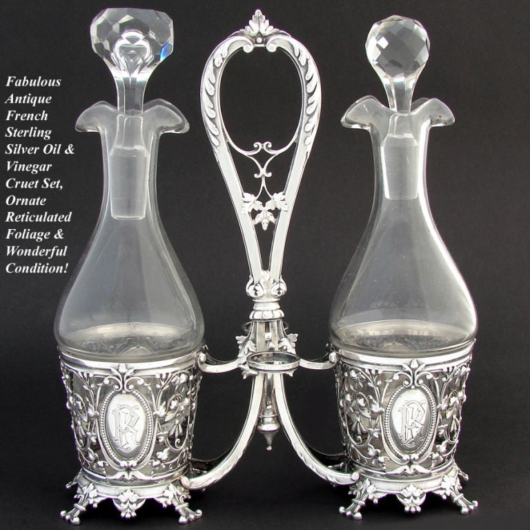 Wonderful antique French Napoleon III to Belle Epoque era sterling silver oil & vinegar cruet stand, unique style with ornate reticulated foliate decoration, tall center handle and foliate feet! Elegant, I just love these old French silver pieces