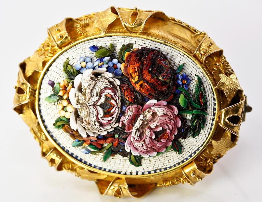 An opulently large Victorian era micromosaic worked in the raised manner to give the floral bouquet a 3-D quality, this elegant memorial or memento brooch is then set in a generous and ornate mount of 18k yellow gold. Backside has a beveled glass