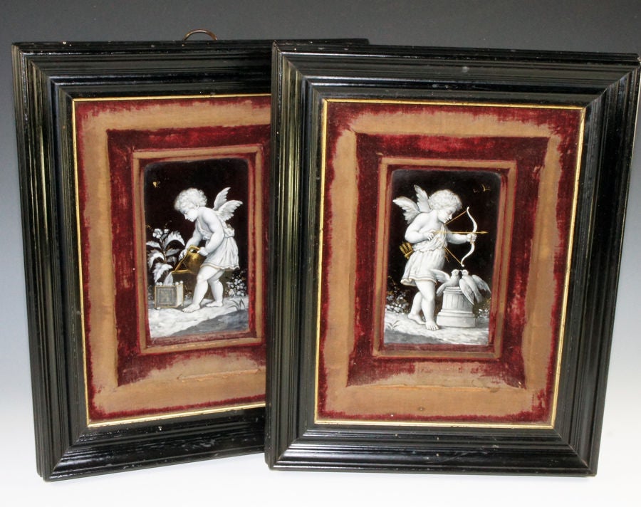 A fabulous find! A matching pair of Napoleon III* era French Limoges enameled plaques, slightly convex rectangles in form, and with a stunning pair of Putti, very well framed in ebony frames with silk velvet-covered serpentine-formed mats, (*circa
