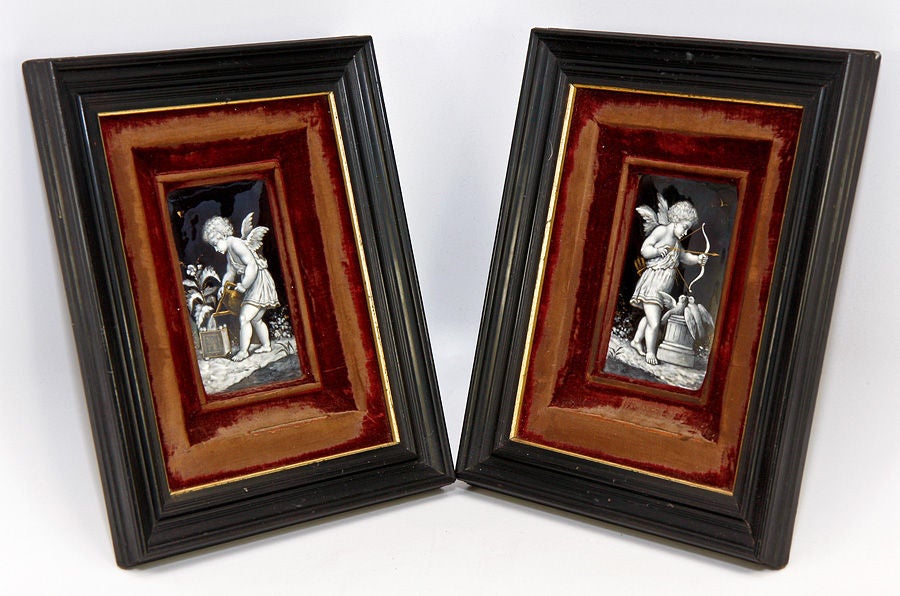 A fabulous find! A matching pair of Napoleon III* era French Limoges enameled plaques, slightly convex rectangles in form, and with a stunning pair of Putti, very well framed in ebony frames with silk velvet-covered serpentine-formed mats, (*circa