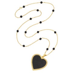 VAN CLEEF & ARPELS An Ebony Wood and Gold Pendant Necklace