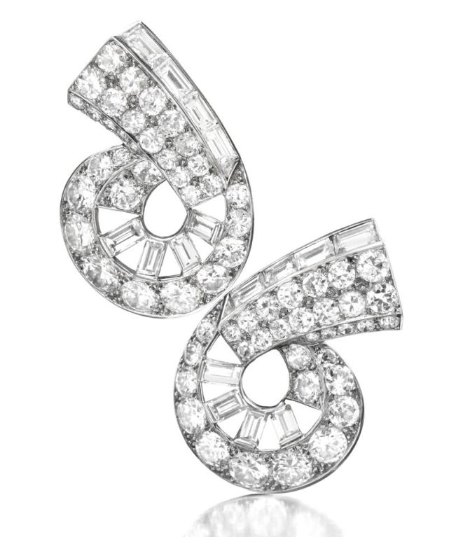 Cartier, A Pair of Art Deco Platinum and Diamond Ear Clips, each designed as a scroll set with graduated circular and baguette-cut diamonds, with French marks, signed Cartier, Paris, numbered L3535, circa 1930.