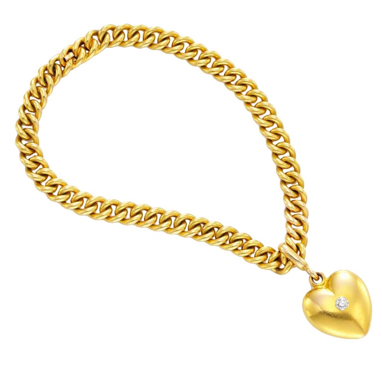 TIFFANY & CO. A Gold and Diamond Heart Charm Bracelet