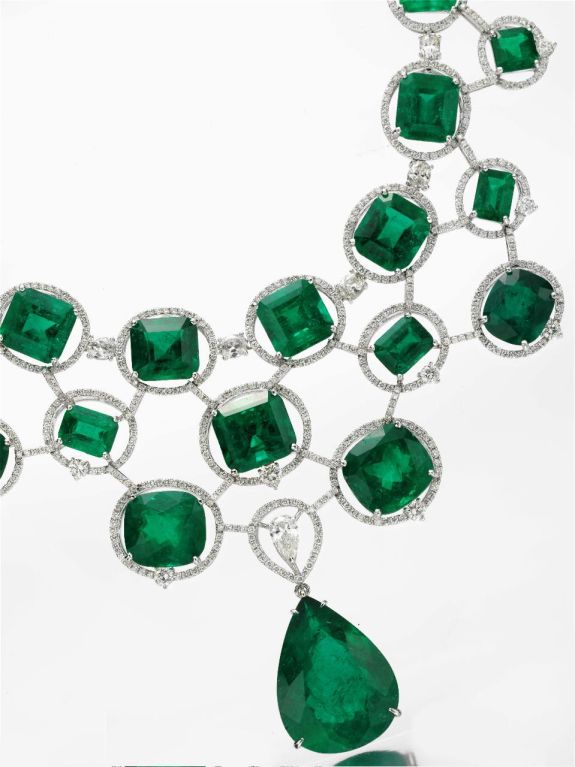 A suite of Colombian emerald and diamond jewelry, comprising of a bib necklace and ear pendants. Emeralds weighing approximately 300.00 carats.  Each emerald accompanied by a laboratory certificate.