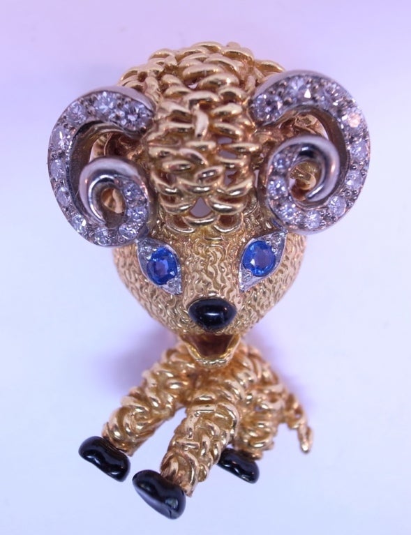 18kt gold and platinum ram brooch, signed VCA and numbered B. 7880, with maker's mark for A.Pery & Cie. <br />
<br />
The horns are set with 18 small brilliant cut diamonds, the eyes are two sapphires, the nose and three legs are accented with