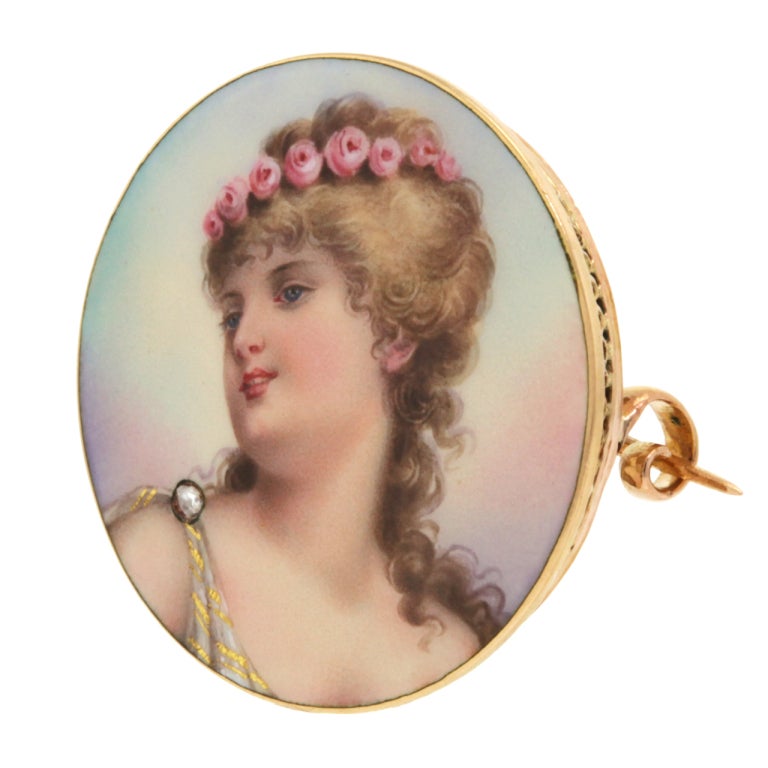 Charming Swiss enamel brooches like this one idealized youth, innocence, and beauty. The stylized neoclassical portrait is superbly executed in colorful enamel and the gold work is equally superb. It is the perfect visual foil for modern