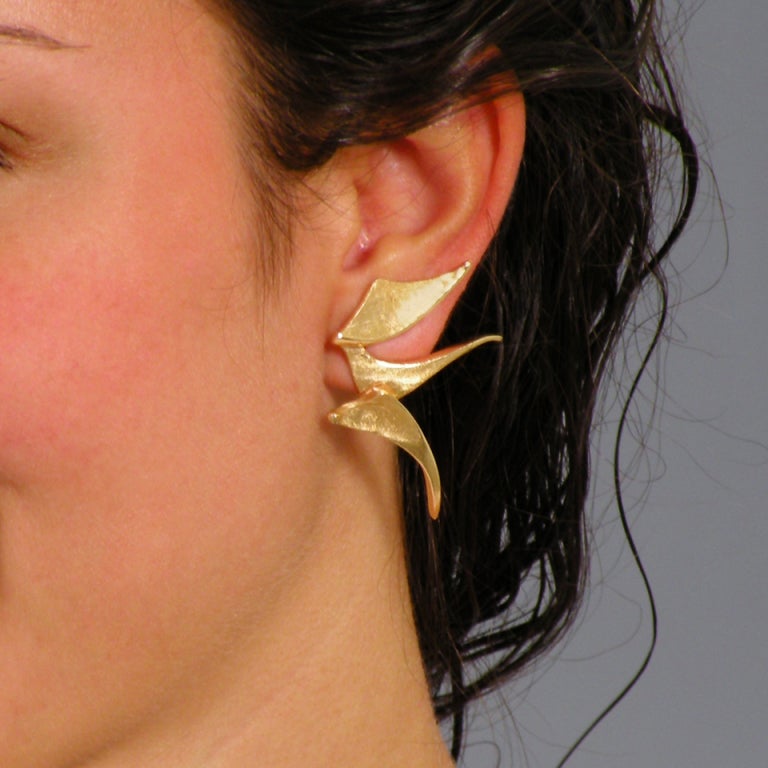 These abstract motif 14k gold earrings are especially fluid examples of Ed Wiener's mid-career work. He liked them enough to feature them on the cover of his catalog. The crude organic construction is an artists ruse. These pieces are sophisticated
