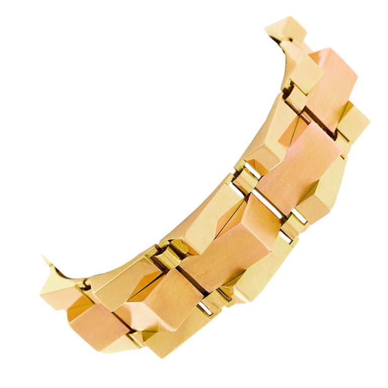 Circa 1930s, 18k, French.  Deco to Retro and Retro to modern, in this bold 18k French bracelet elements of all three aesthetic movements are present. Its chic geometry is underscored by the delicious artistic tension of juxtaposed bi-color polished