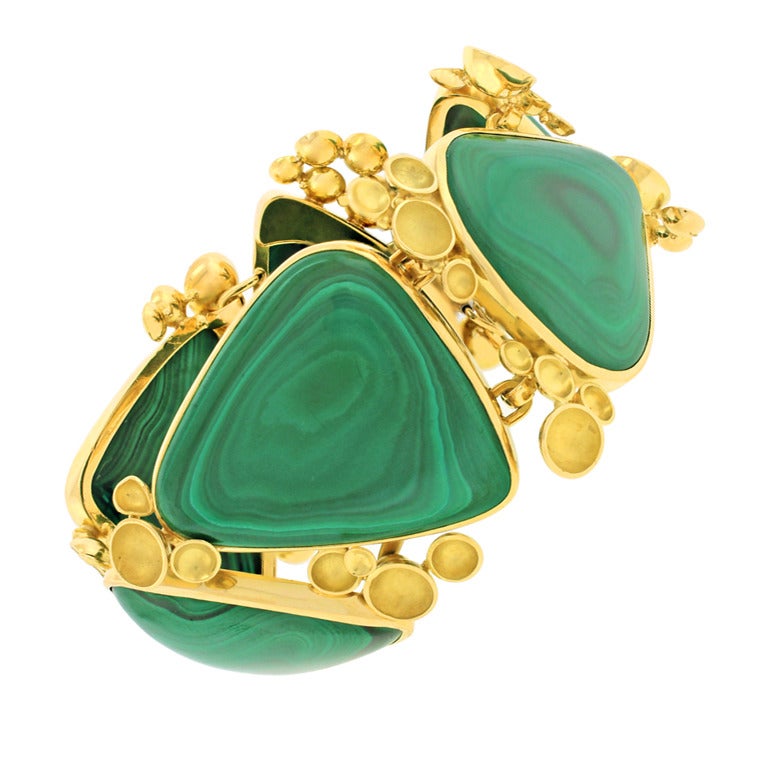 Circa 1960-70s, 18k, Switzerland.  This spectacular 18k biomorphic bracelet features a surreal landscape of pod plants and shifting color. The look is pop art at its sixties chic best. Set with superbly figured malachite and meticulously handmade,